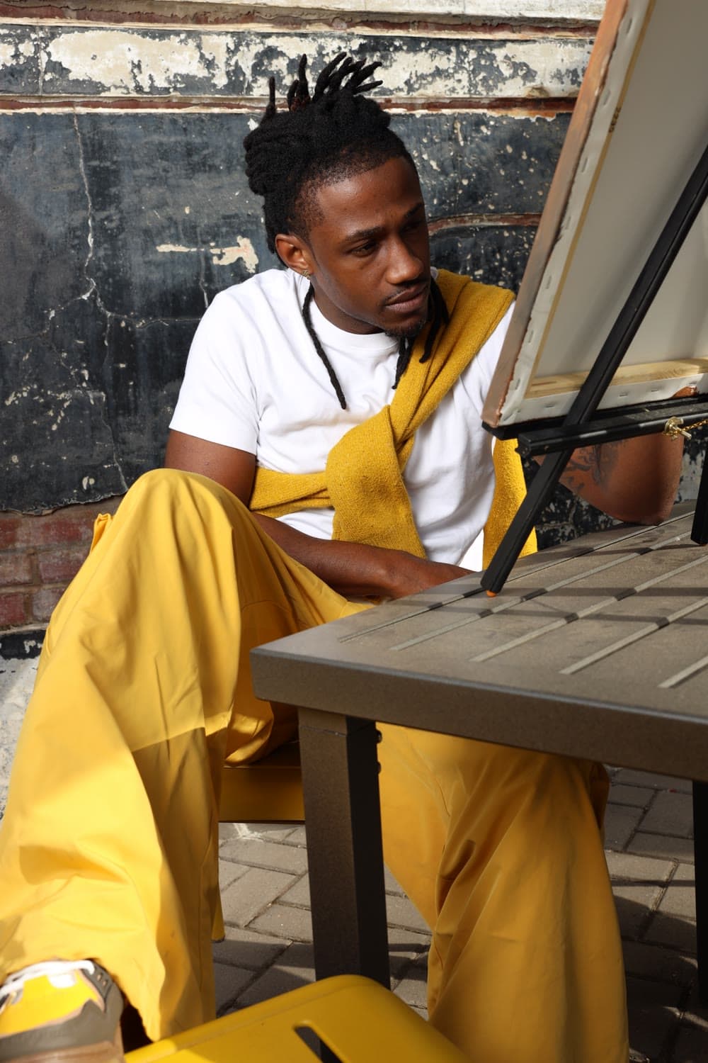 Marley, the artist behind Natural Art Studios, at his easel in Charlotte